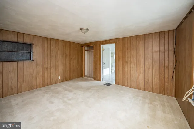 a view of an empty room with wooden door