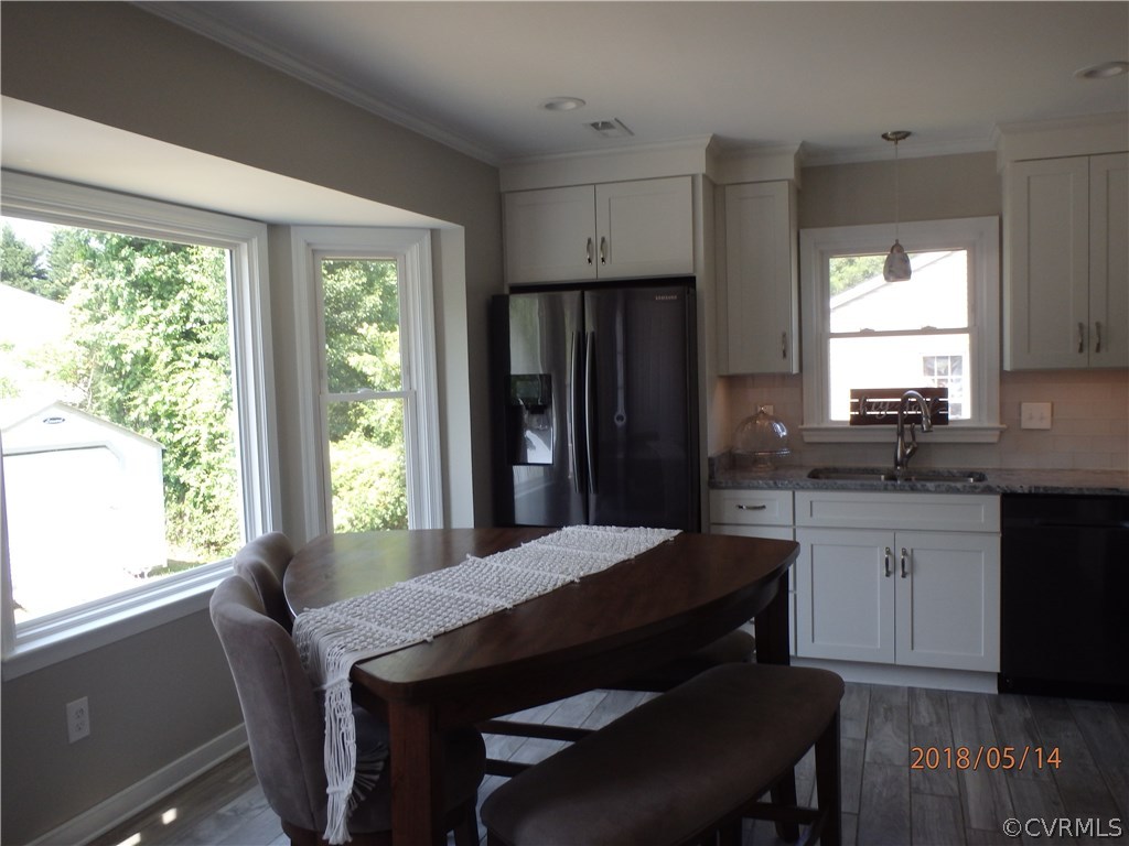5036 Alberta Road Chesterfield, VA 23832 - Photo 15 of 20 a kitchen with granite countertop sink dining table and chairs