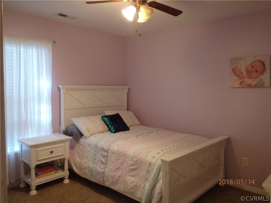 5036 Alberta Road Chesterfield, VA 23832 - Photo 17 of 20 a bedroom with a bed and a chandelier