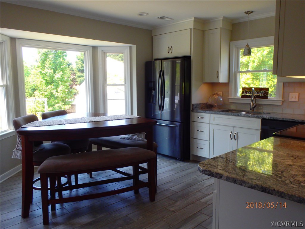 5036 Alberta Road Chesterfield, VA 23832 - Photo 6 of 20 a kitchen with granite countertop wooden floors and wooden cabinets