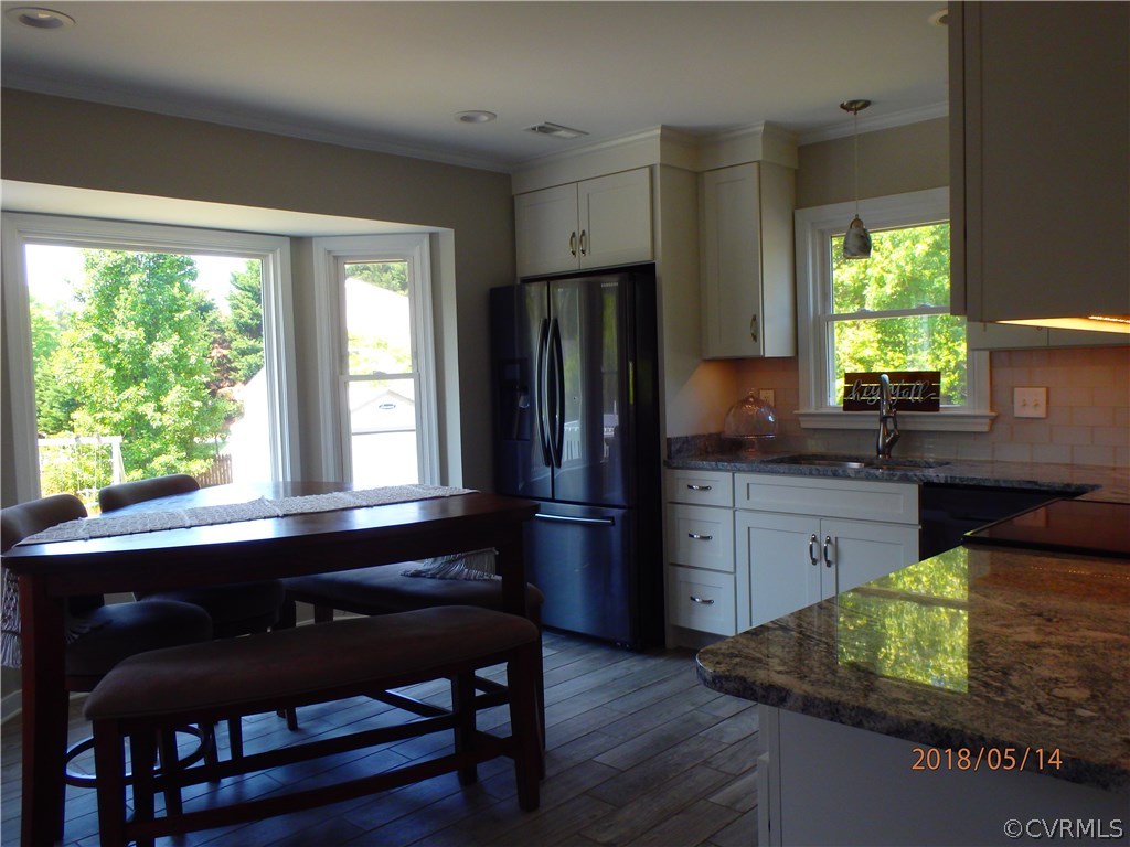 5036 Alberta Road Chesterfield, VA 23832 - Photo 7 of 20 a kitchen with stainless steel appliances granite countertop a refrigerator a stove a sink dishwasher and wooden cabinets with wooden floor