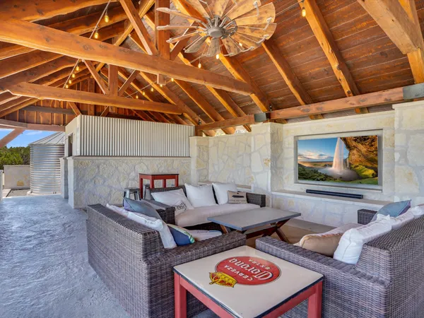 a view of a patio with couches and pool
