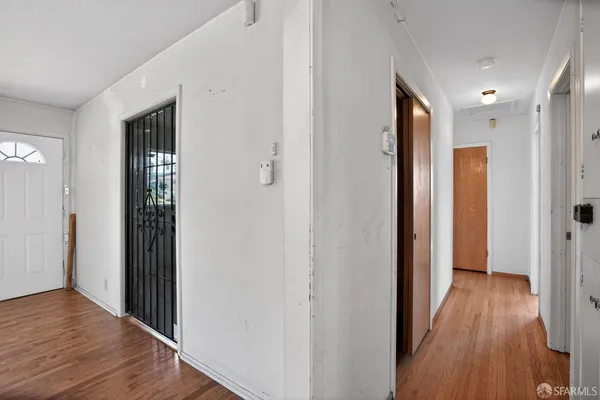 a view of hallway with wooden floor