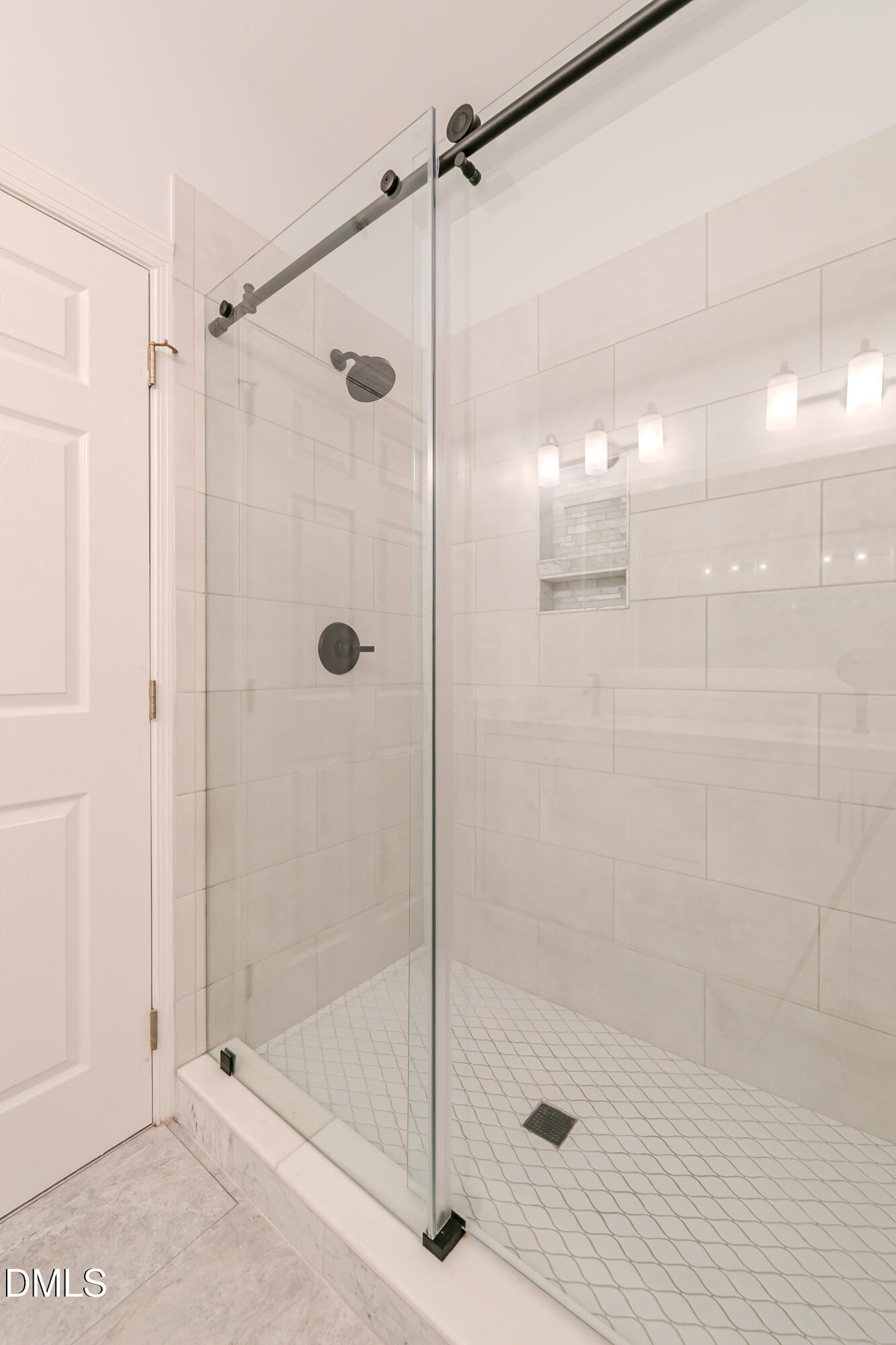 116 Northbrook Drive, Unit 305 Raleigh, NC 27609 - Photo 34 of 43 a bathroom with a glass door shower