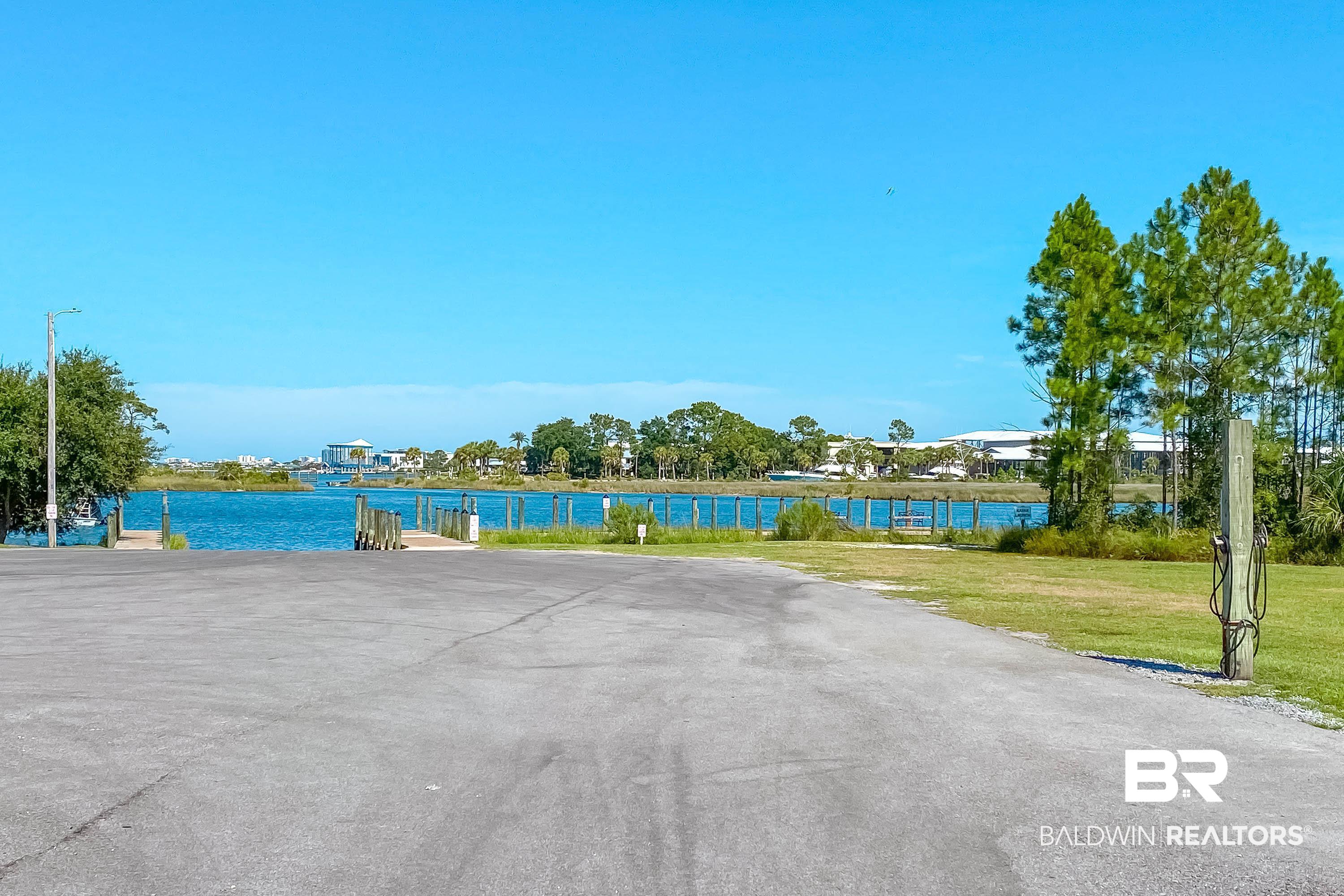 4144 Harbor Road Orange Beach, AL 36561 - Photo 58 of 62 Exterior space featuring a lawn and a water view