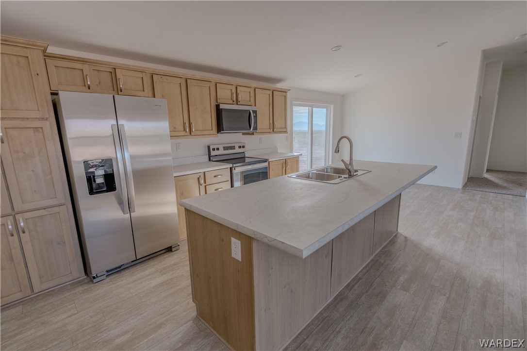 5746 Eden Road Golden Valley, AZ 86413 - Photo 6 of 27 a kitchen with kitchen island a counter top space stainless steel appliances and cabinets