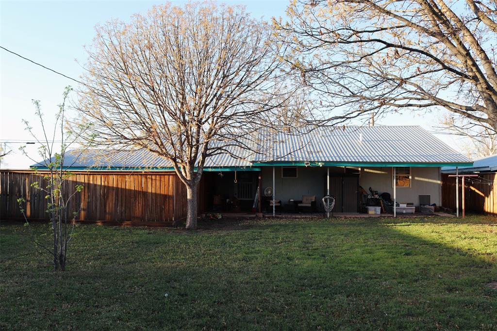 109 Novice Road Winters, TX 79567 - Photo 12 of 32 a view of a house with backyard and a tree
