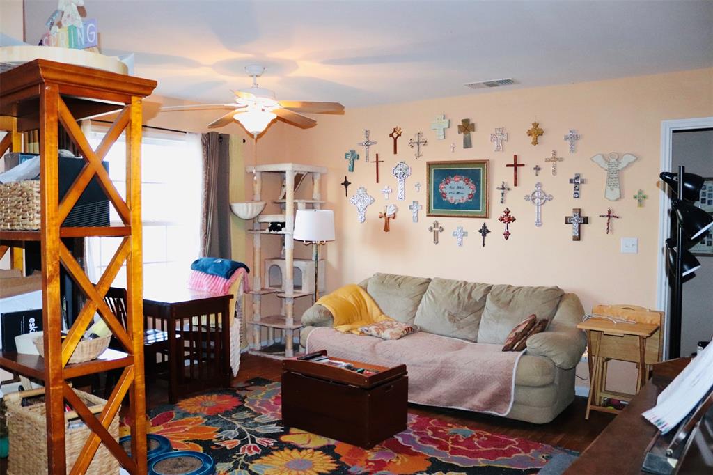 109 Novice Road Winters, TX 79567 - Photo 19 of 32 a living room with furniture a rug and a wall painting