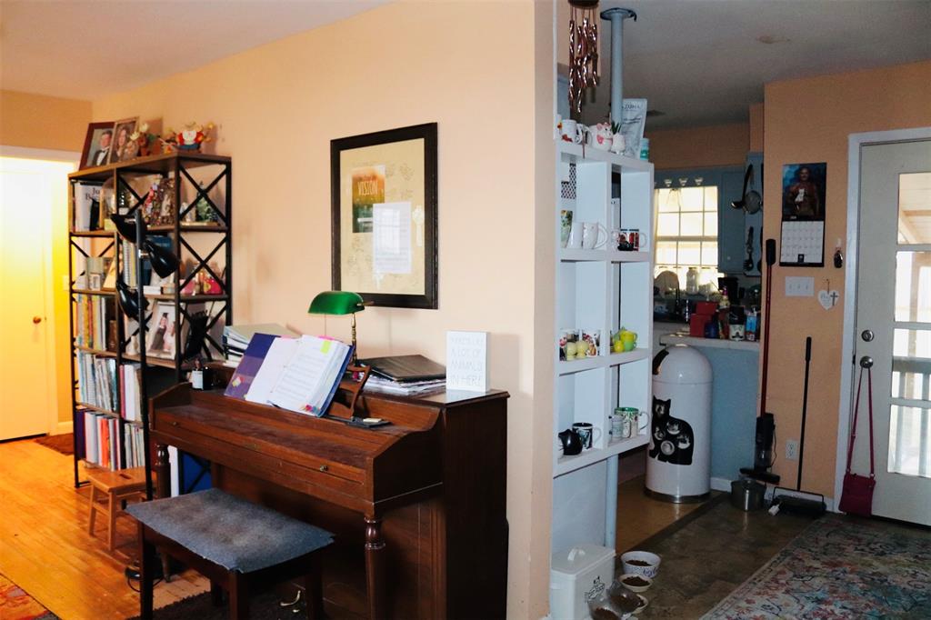 109 Novice Road Winters, TX 79567 - Photo 20 of 32 a living room with furniture a piano and a chandelier