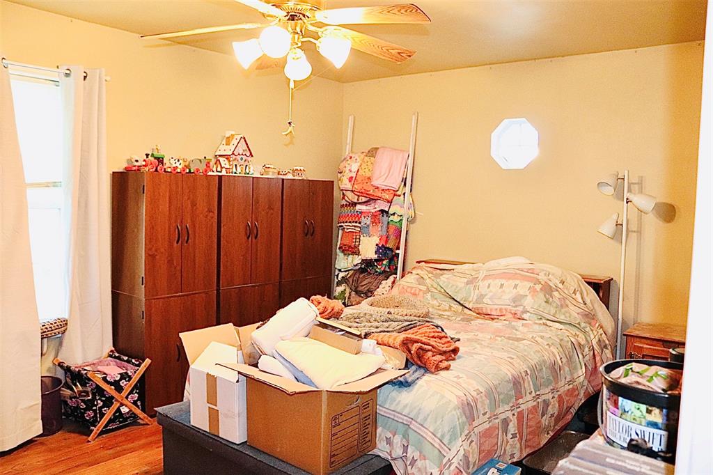 109 Novice Road Winters, TX 79567 - Photo 22 of 32 a bed sitting in a bedroom next to a window