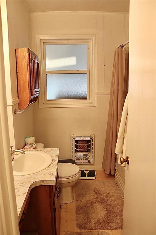 109 Novice Road Winters, TX 79567 - Photo 24 of 32 a bathroom with a sink a toilet and mirror
