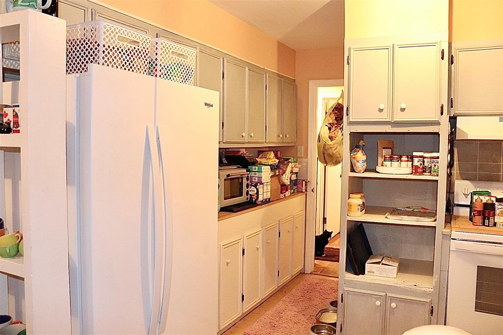 109 Novice Road Winters, TX 79567 - Photo 25 of 32 a kitchen with stainless steel appliances a refrigerator and cabinets