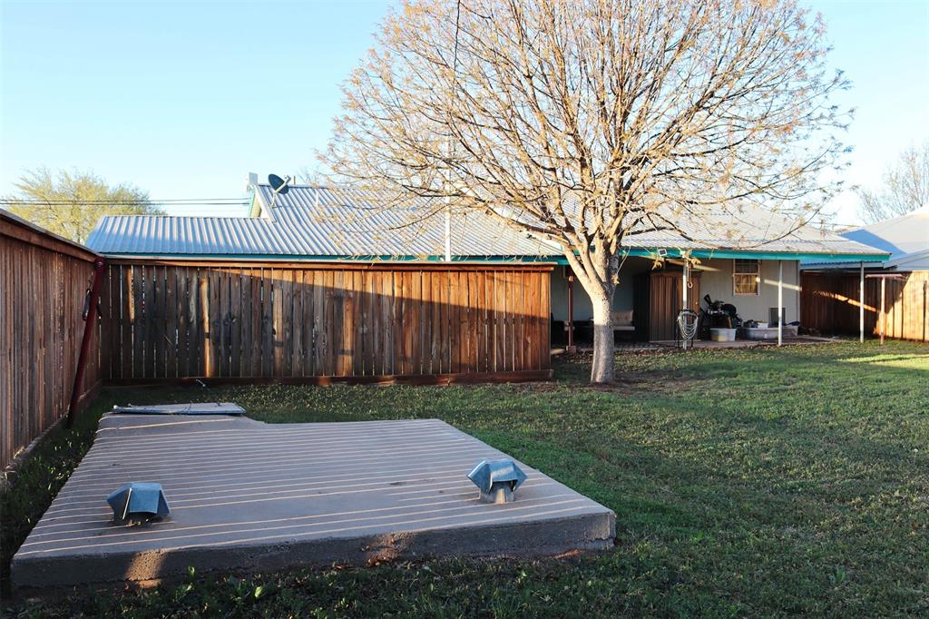 109 Novice Road Winters, TX 79567 - Photo 7 of 32 a view of a backyard with wooden fence
