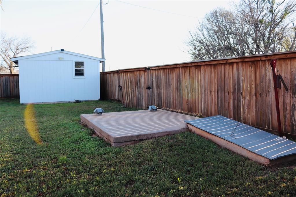 109 Novice Road Winters, TX 79567 - Photo 9 of 32 a view of a backyard with a wooden fence