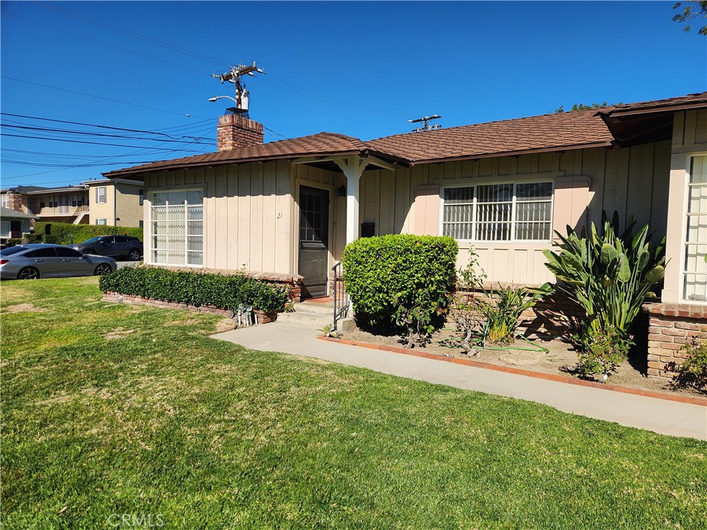 a front view of a house with a yard and porch