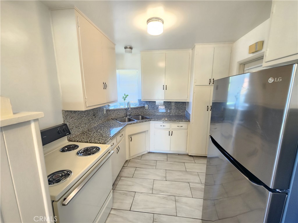 21 West Newman Avenue Arcadia, CA 91007 - Photo 13 of 29 a kitchen with a refrigerator sink and cabinets