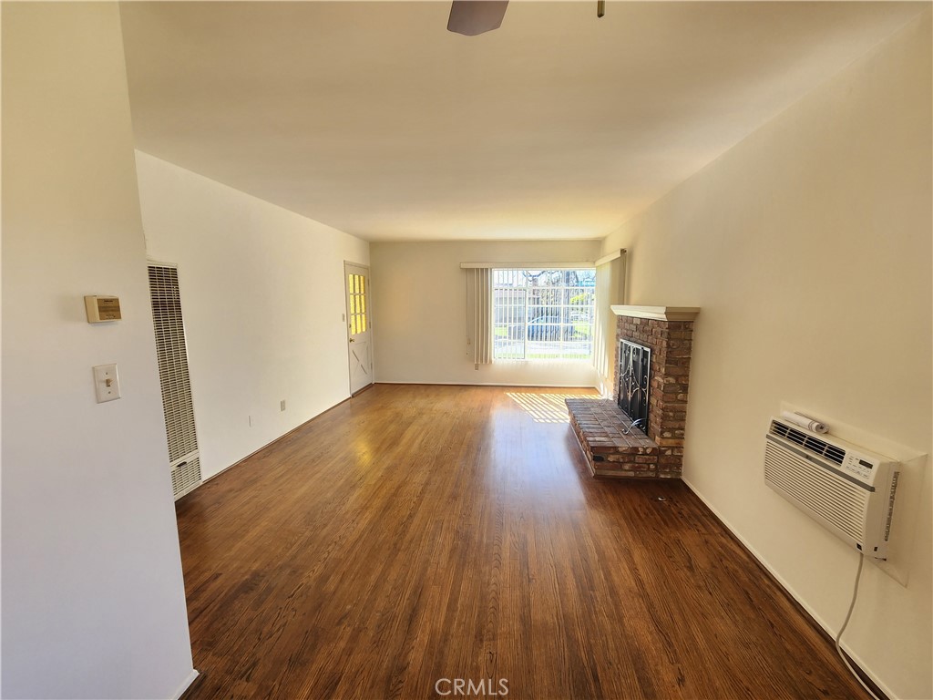 21 West Newman Avenue Arcadia, CA 91007 - Photo 10 of 29 a view of empty room with fireplace and wooden floor