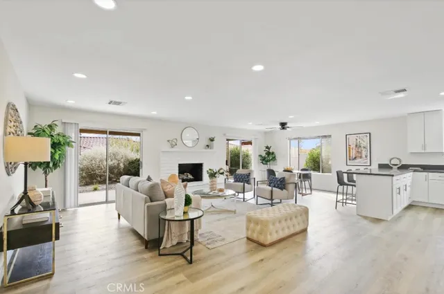 a living room with fireplace furniture and a wooden floor