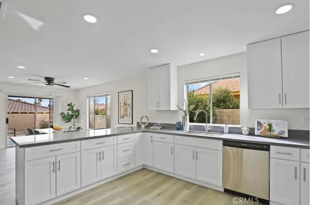 a kitchen with sink a window and cabinets