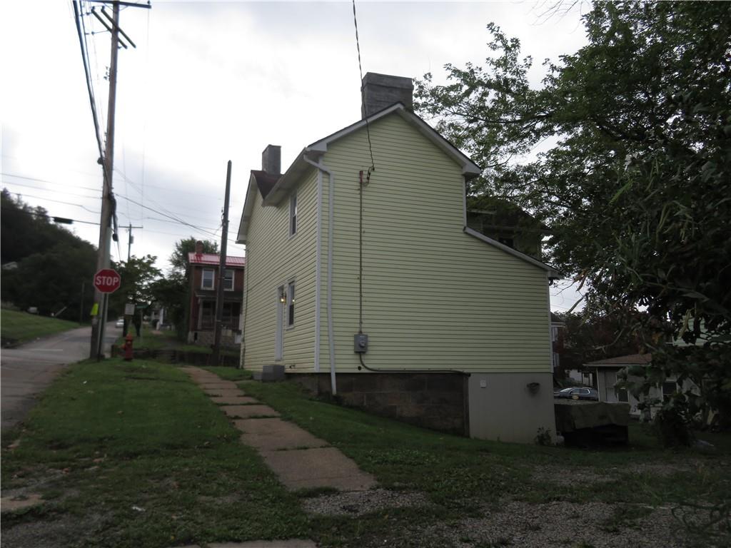 326 1st Street Apollo, PA 15613 - Photo 3 of 17 a backyard of a house with plants and tree
