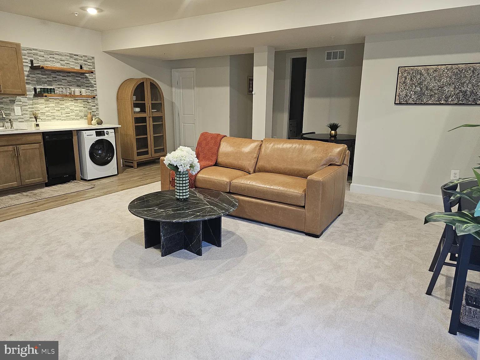 1425 Two Rivers Boulevard Odenton, MD 21113 - Photo 3 of 11 a living room with furniture a chandelier and a flat screen tv