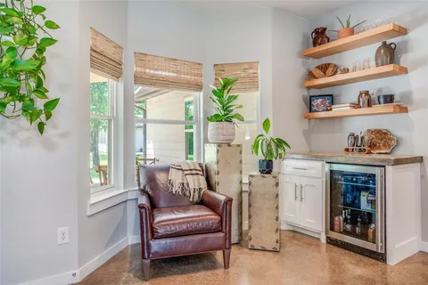 a living room with furniture and a potted plant