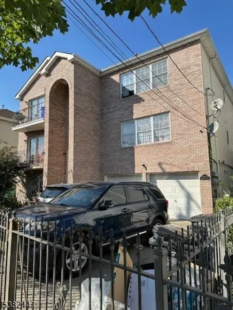 a front view of a house with parking space