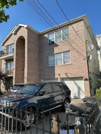 a front view of a house with parking space