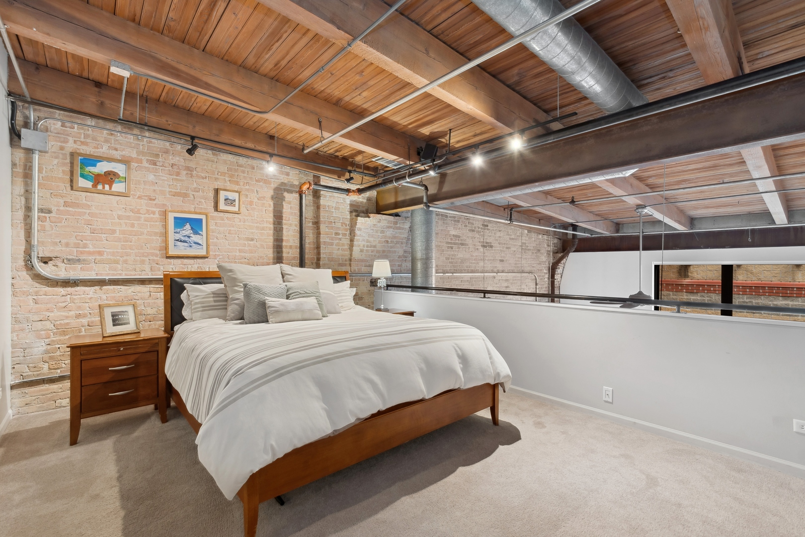 22 North Morgan Street, Unit 202 Chicago, IL 60607 - Photo 11 of 29 a spacious bedroom with a bed and a chandelier