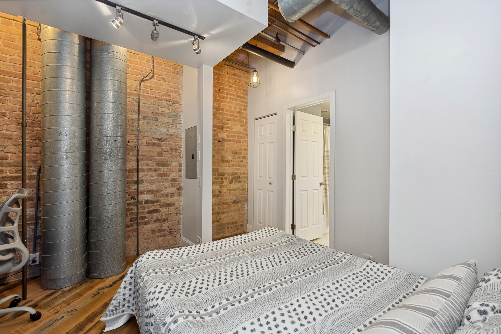 22 North Morgan Street, Unit 202 Chicago, IL 60607 - Photo 16 of 29 a bedroom with a bed next to a window