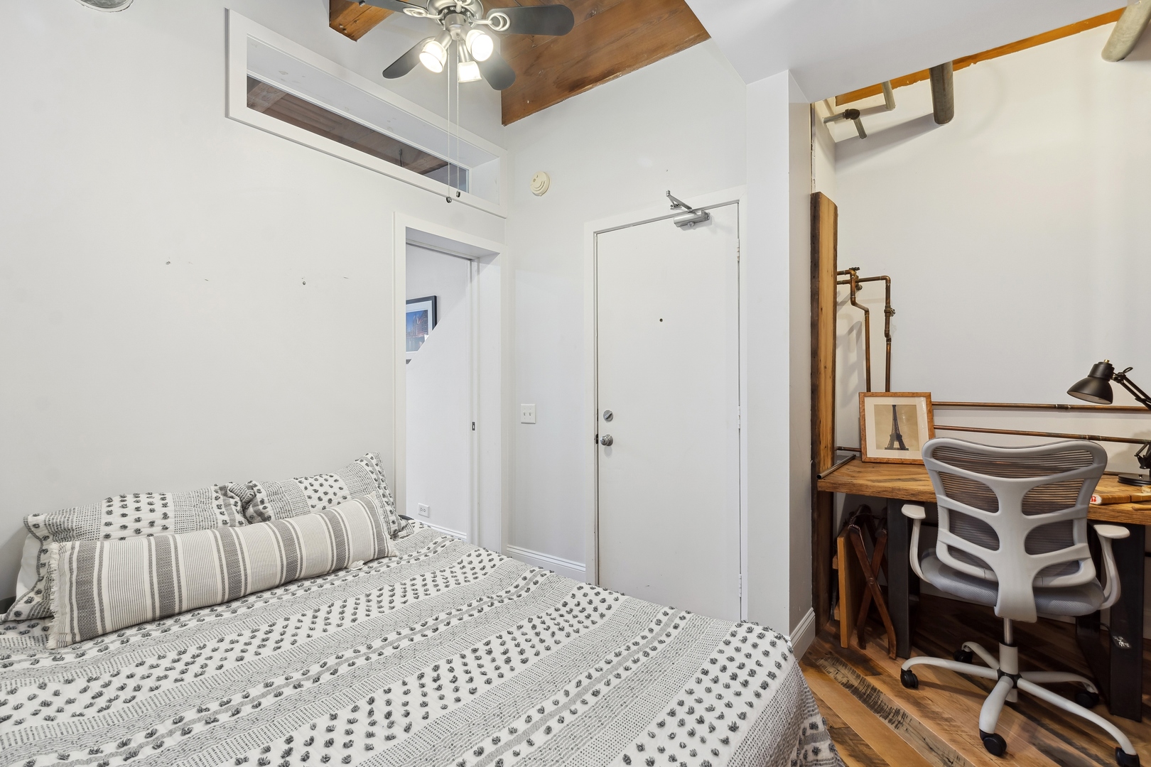 22 North Morgan Street, Unit 202 Chicago, IL 60607 - Photo 17 of 29 a bedroom with a bed and wooden floor