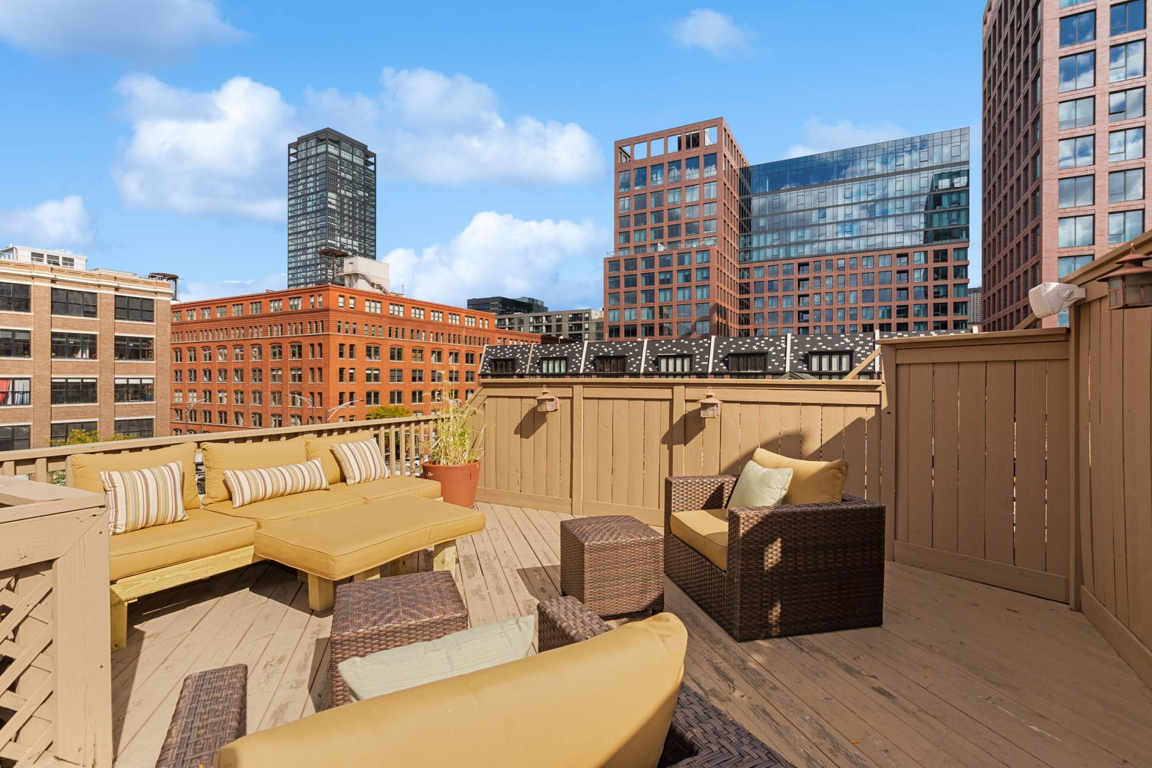 22 North Morgan Street, Unit 202 Chicago, IL 60607 - Photo 21 of 29 a balcony with a couch and wooden cabinets