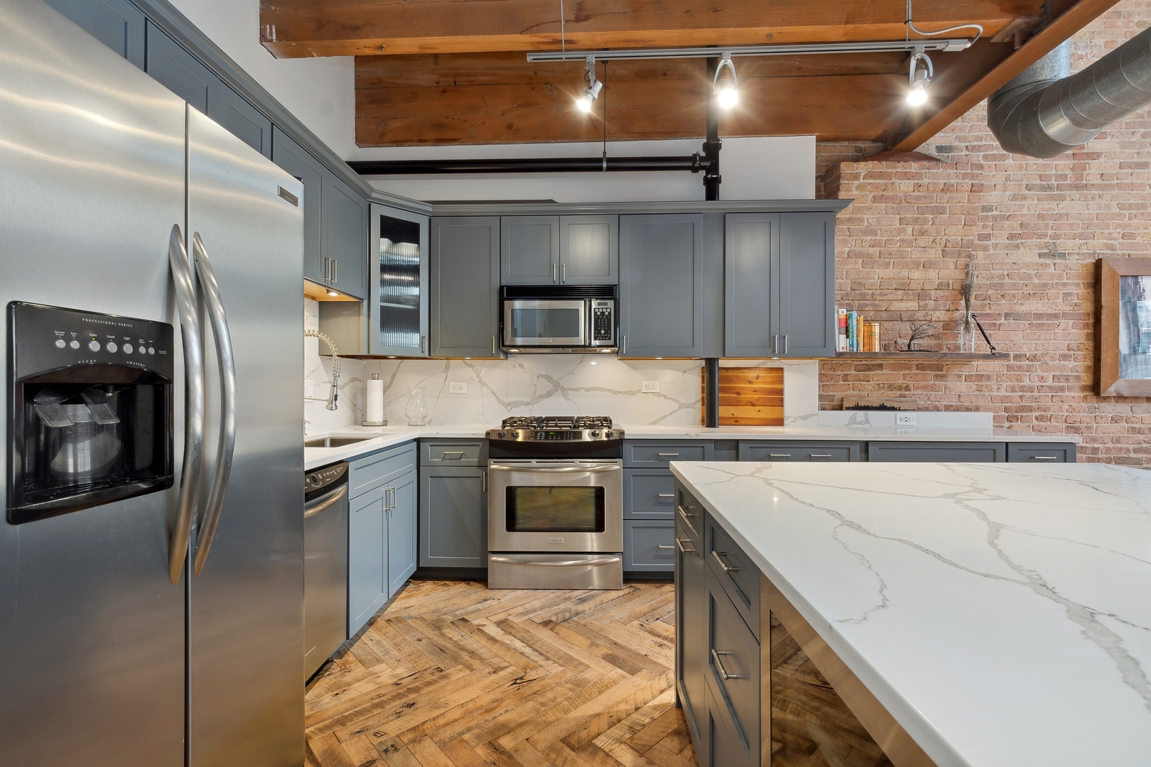 22 North Morgan Street, Unit 202 Chicago, IL 60607 - Photo 9 of 29 a kitchen with stainless steel appliances granite countertop a sink a stove and a refrigerator