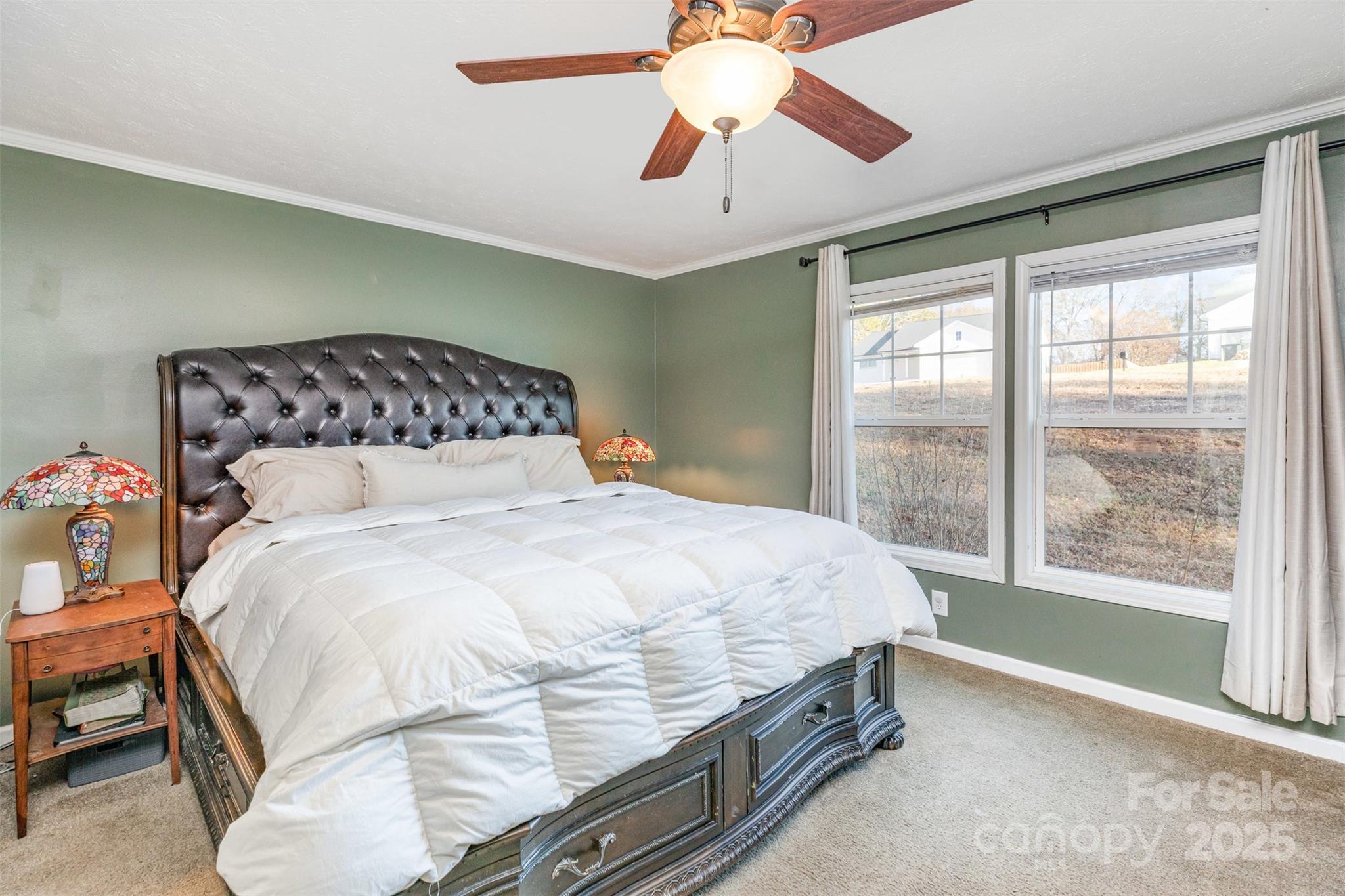 4110 Pebblebrook Circle Southwest Concord, NC 28027 - Photo 15 of 39 a bedroom with a large bed and a chandelier