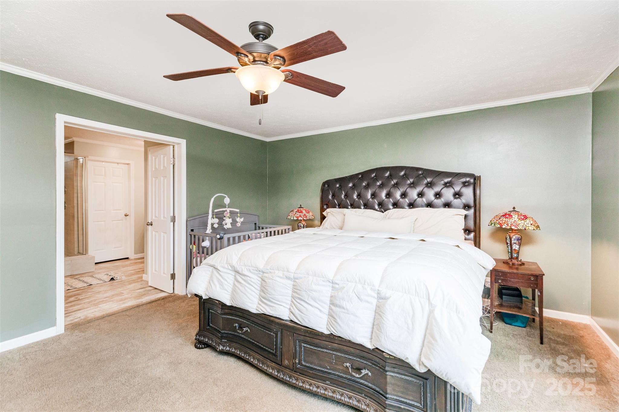 4110 Pebblebrook Circle Southwest Concord, NC 28027 - Photo 16 of 39 a bedroom with a bed and a chandelier