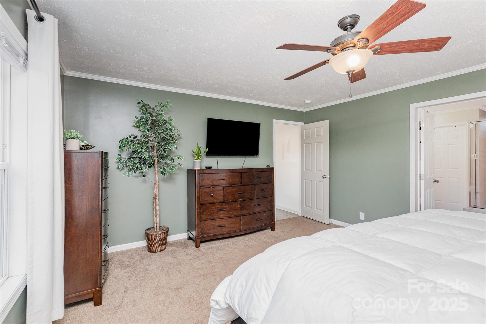 4110 Pebblebrook Circle Southwest Concord, NC 28027 - Photo 17 of 39 a bedroom with a bed and a flat screen tv