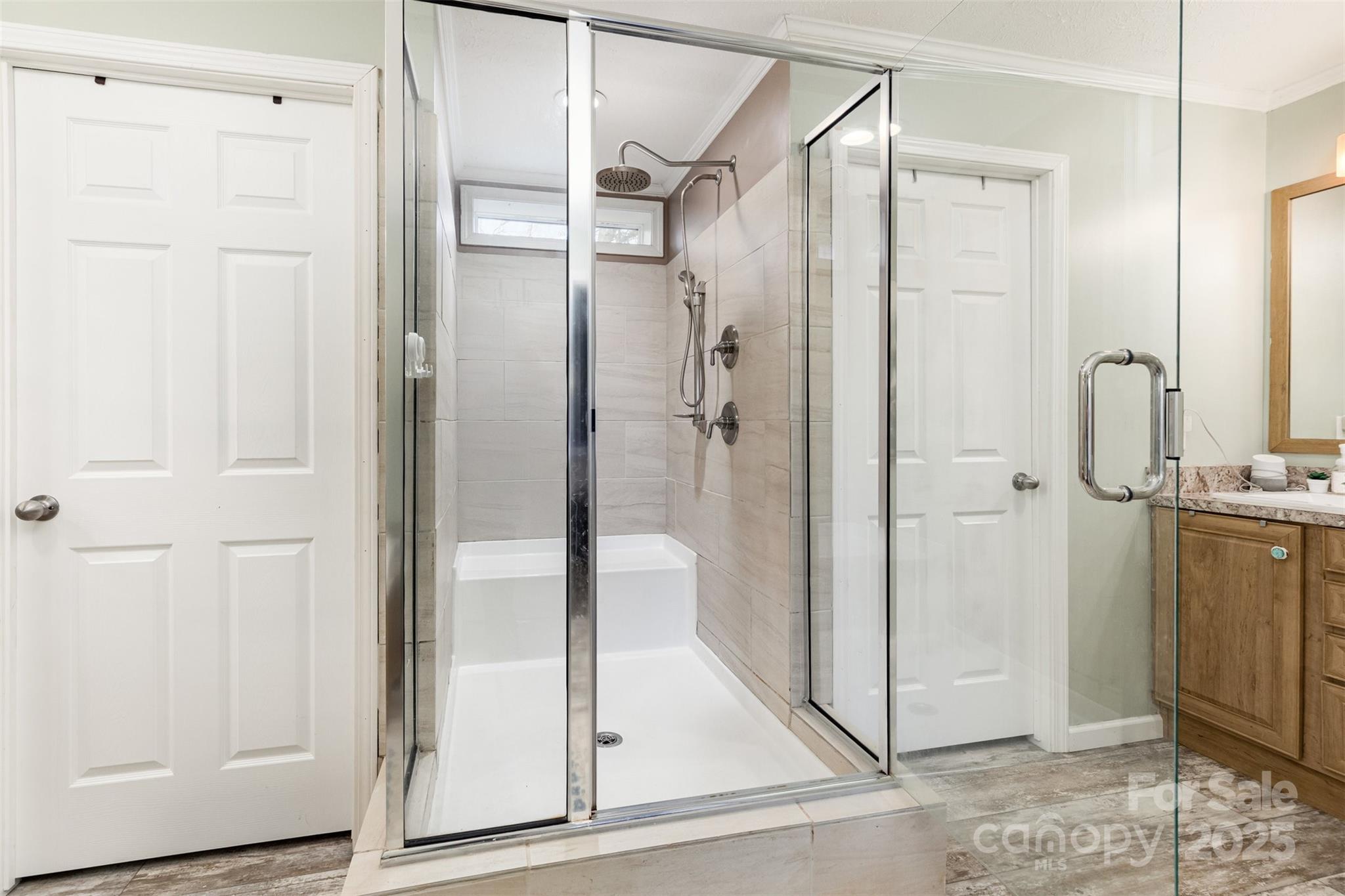 4110 Pebblebrook Circle Southwest Concord, NC 28027 - Photo 20 of 39 a bathroom with a glass shower door