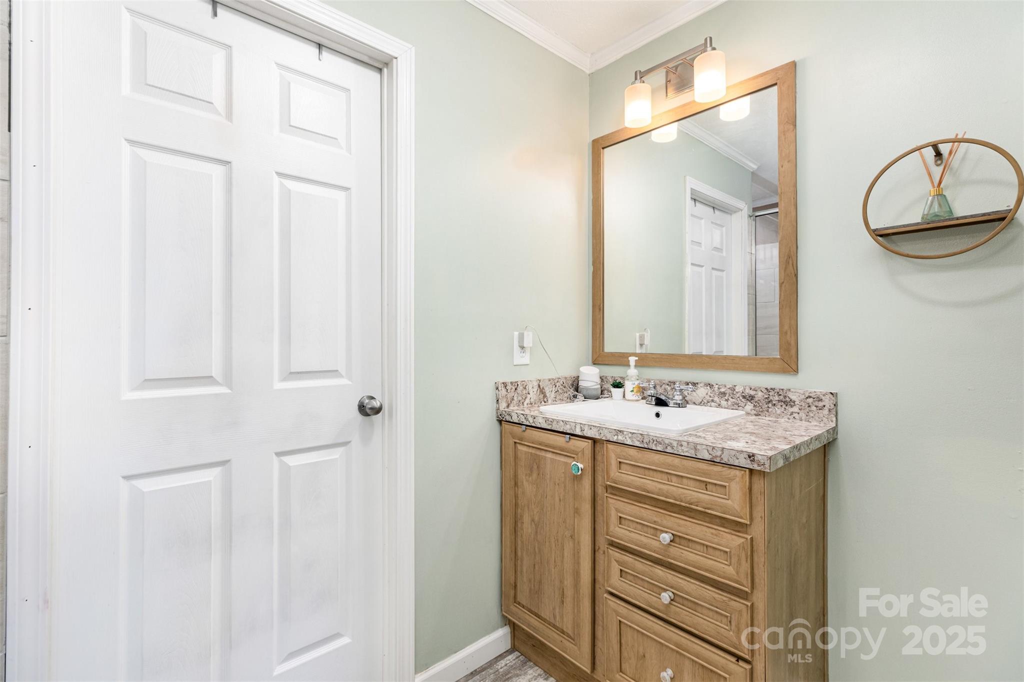 4110 Pebblebrook Circle Southwest Concord, NC 28027 - Photo 22 of 39 a bathroom with a sink vanity and a mirror