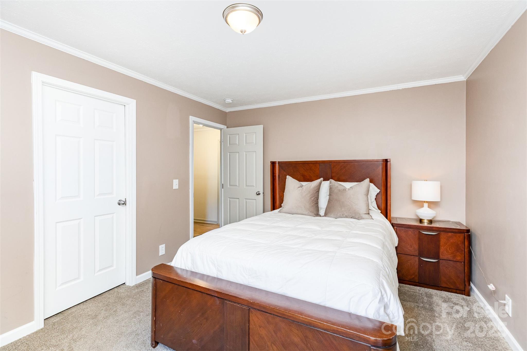 4110 Pebblebrook Circle Southwest Concord, NC 28027 - Photo 23 of 39 a bedroom with a bed and a night stand