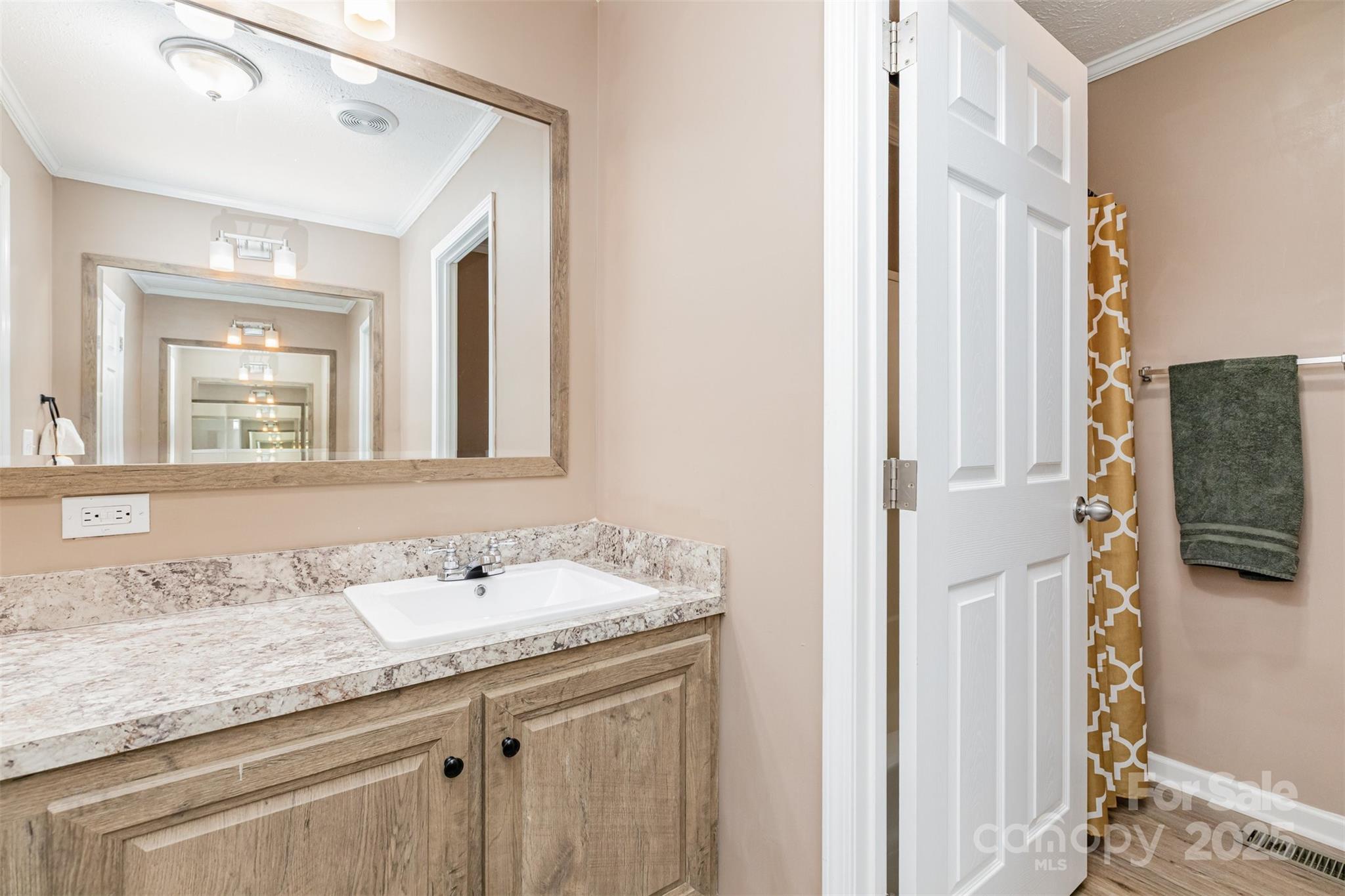 4110 Pebblebrook Circle Southwest Concord, NC 28027 - Photo 24 of 39 a bathroom with a granite countertop sink and a mirror