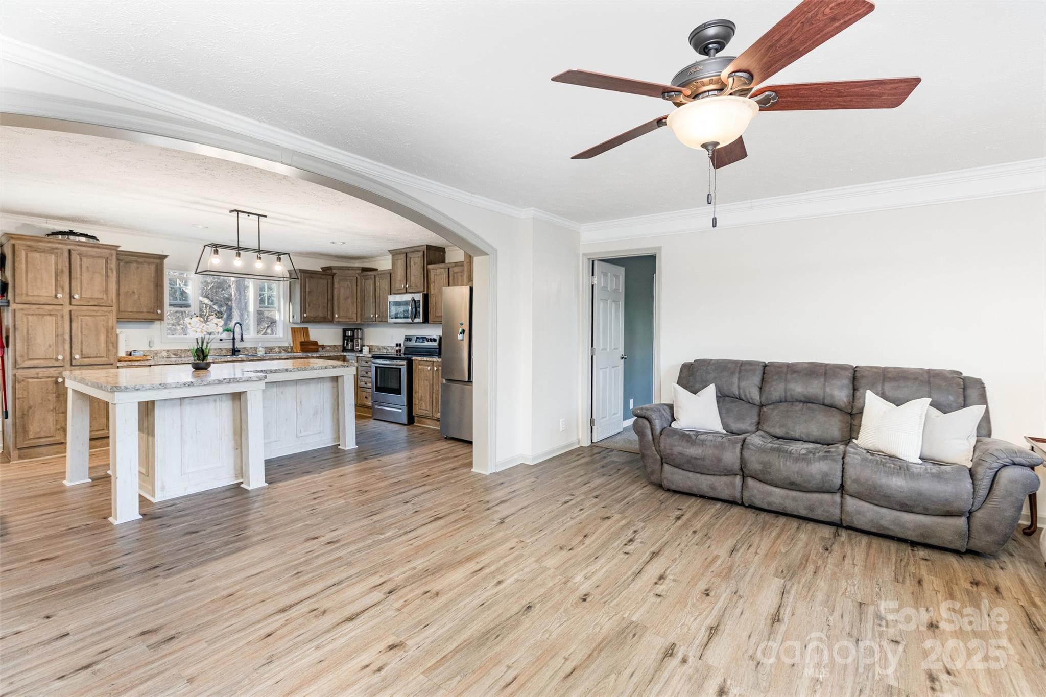 4110 Pebblebrook Circle Southwest Concord, NC 28027 - Photo 5 of 39 a living room with stainless steel appliances furniture and a kitchen view