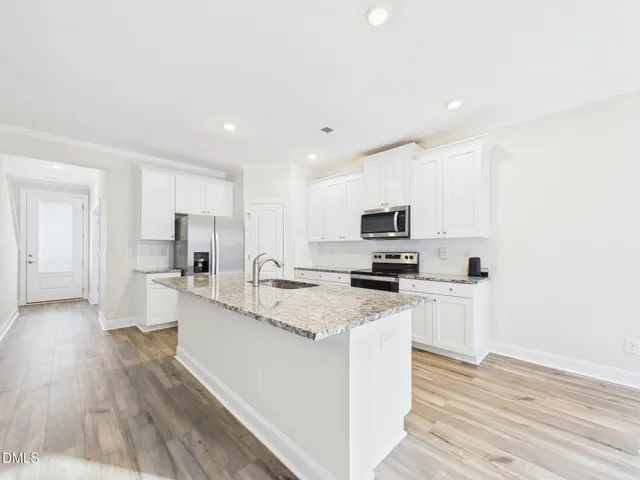 a bathroom with a granite countertop sink toilet mirror and bathtub