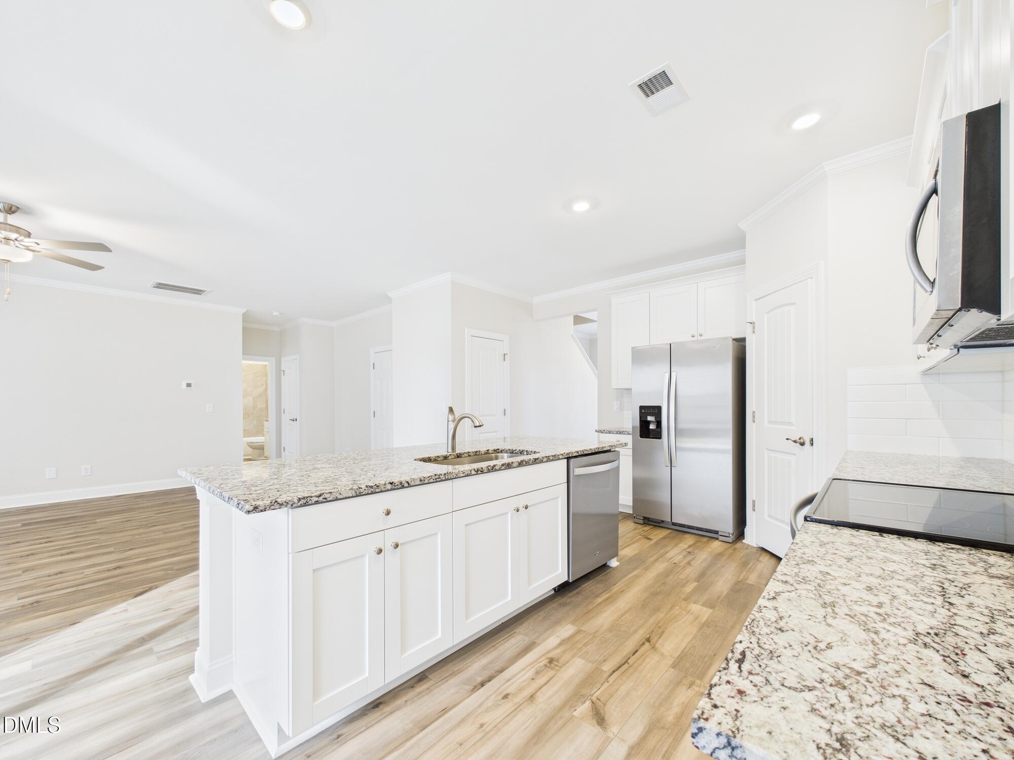 110 Symmetry Loop Youngsville, NC 27596 - Photo 21 of 72 a spacious bathroom with a granite countertop sink a toilet a mirror and shower