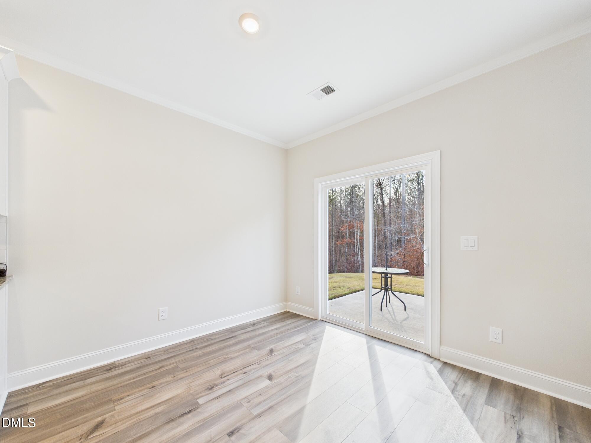 110 Symmetry Loop Youngsville, NC 27596 - Photo 26 of 72 wooden floor in an empty room with a window
