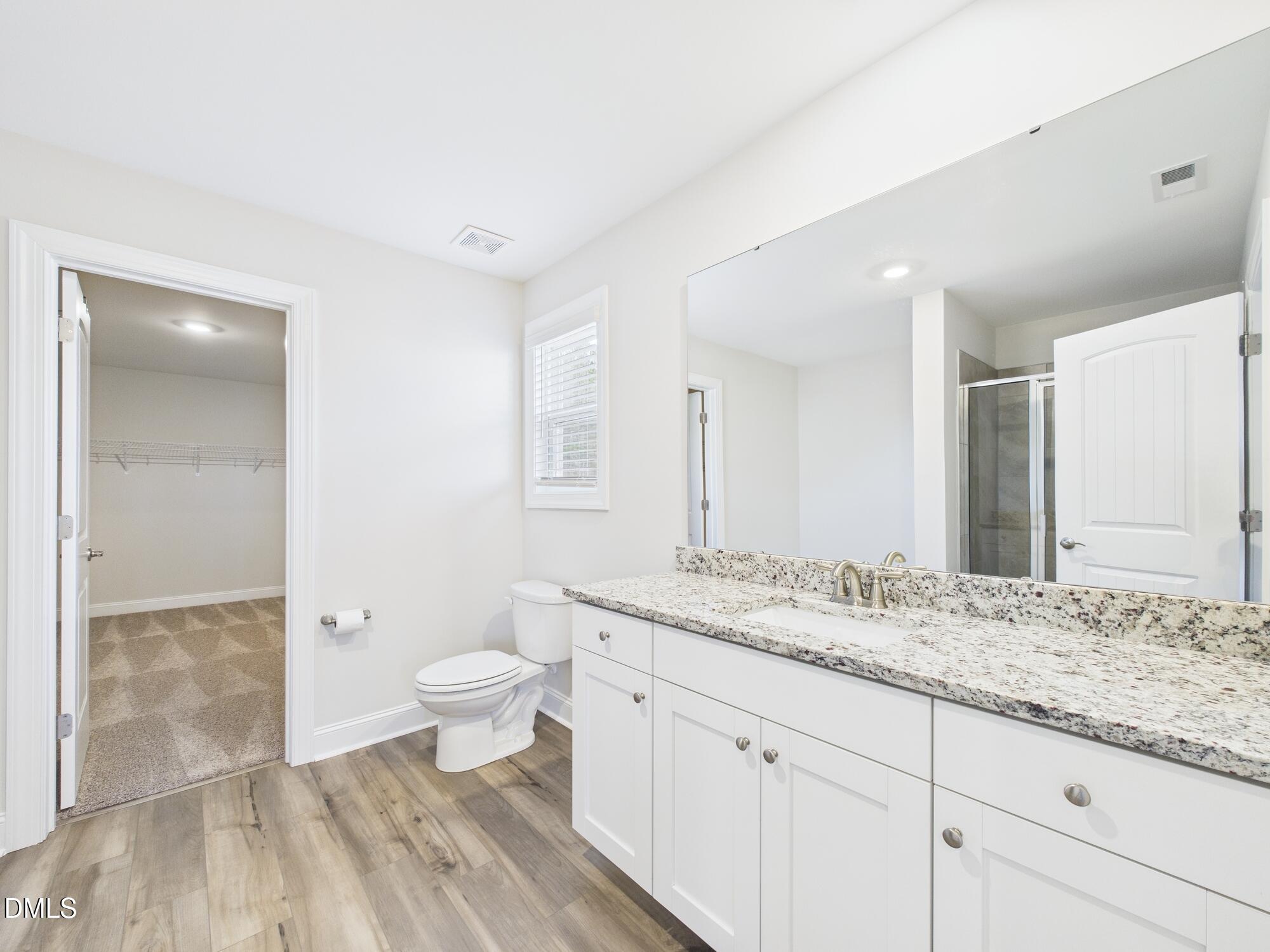 110 Symmetry Loop Youngsville, NC 27596 - Photo 40 of 72 a bathroom with a granite countertop sink toilet and shower