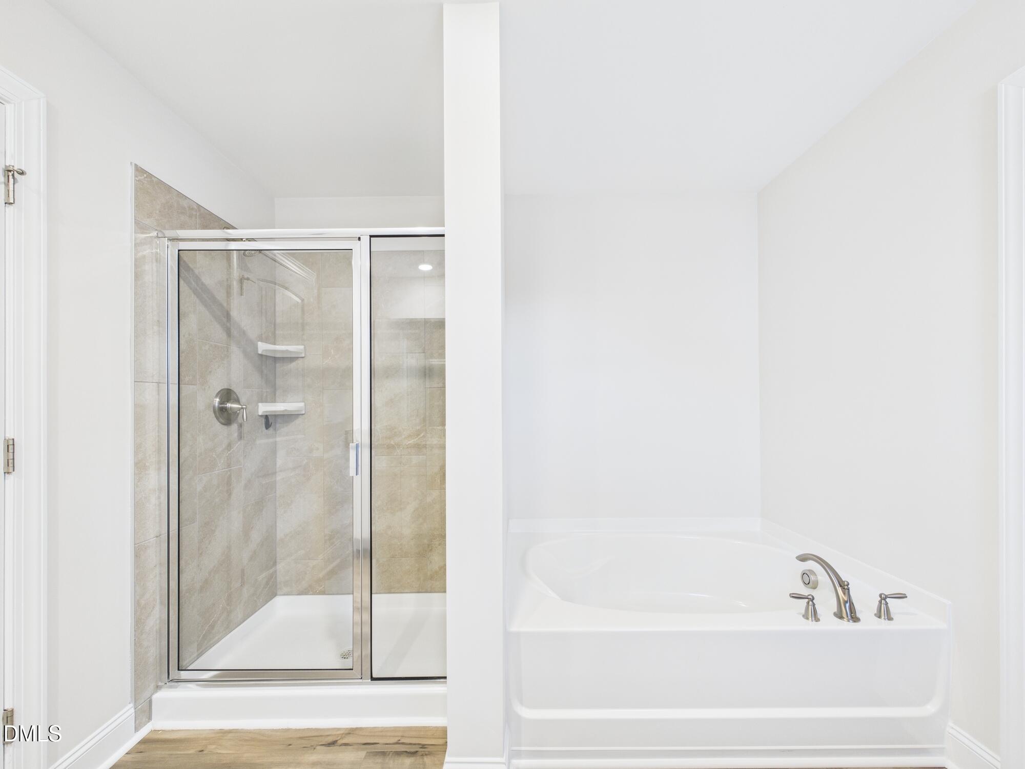 110 Symmetry Loop Youngsville, NC 27596 - Photo 42 of 72 a bathroom with a bathtub and a shower