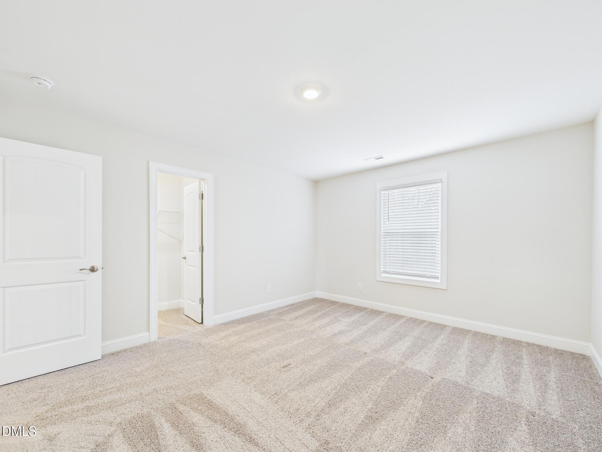 110 Symmetry Loop Youngsville, NC 27596 - Photo 50 of 72 an empty room with a empty space and windows