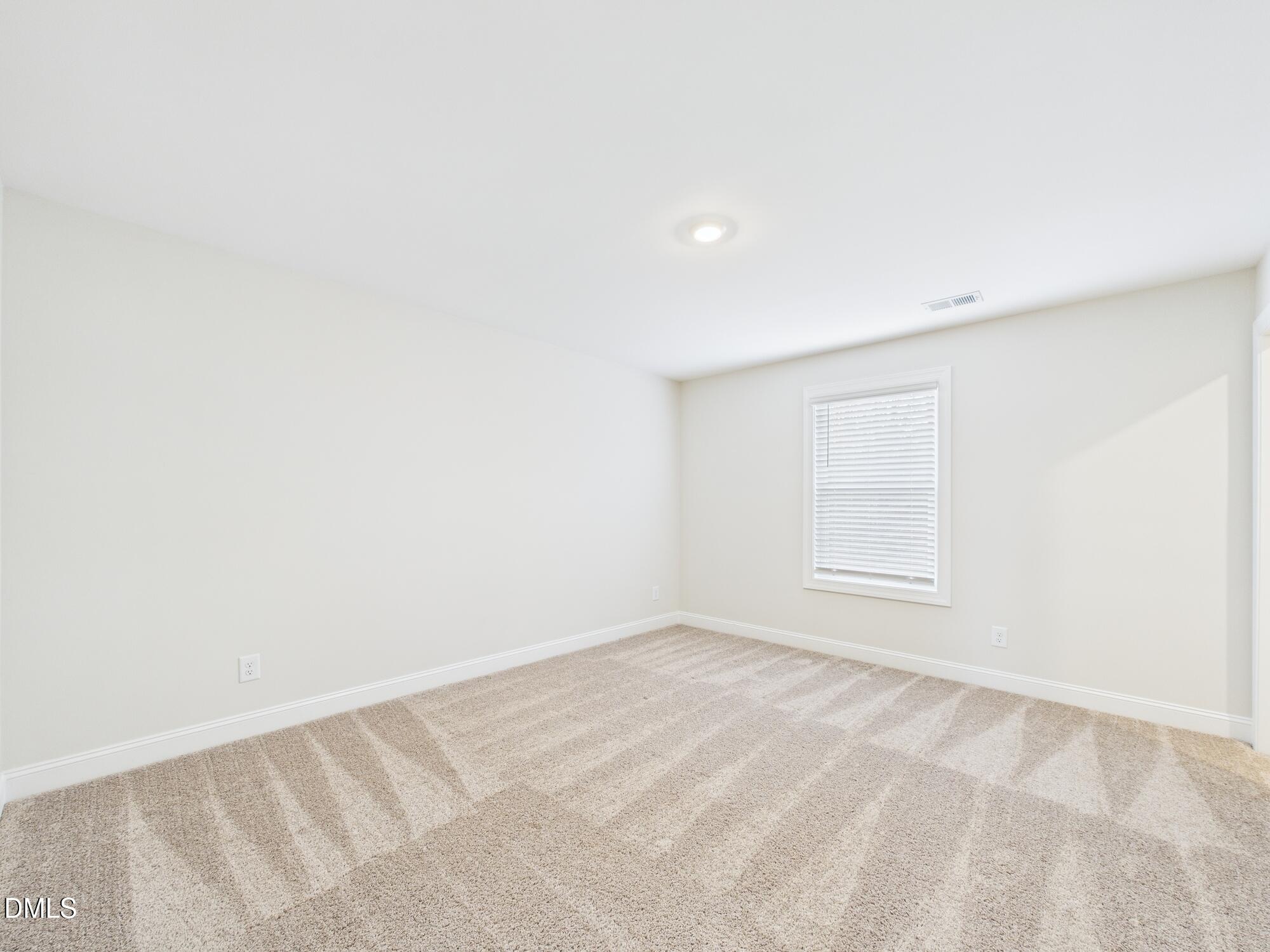 110 Symmetry Loop Youngsville, NC 27596 - Photo 54 of 72 an empty room with a window