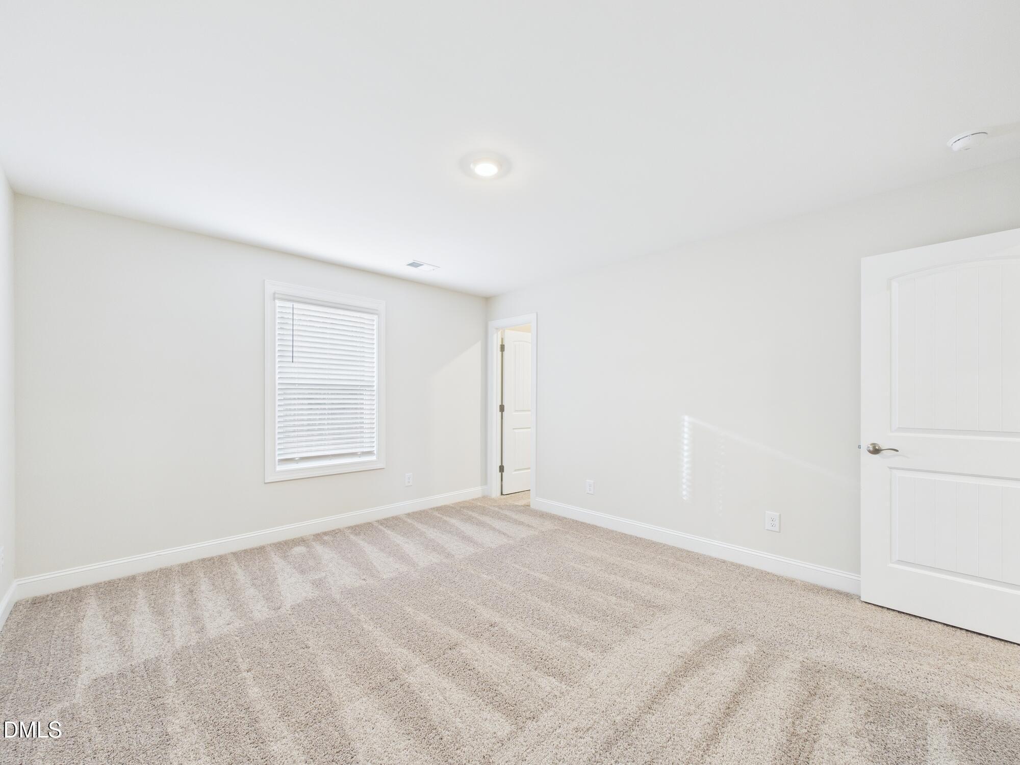 110 Symmetry Loop Youngsville, NC 27596 - Photo 55 of 72 a view of an empty room with a window