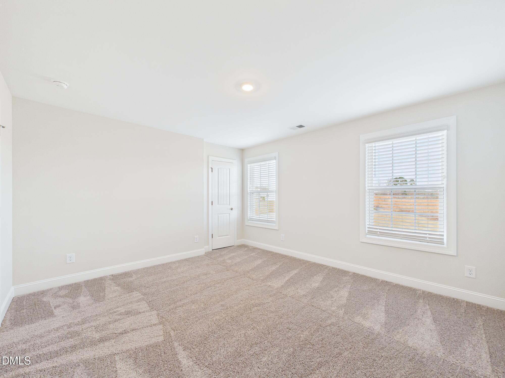 110 Symmetry Loop Youngsville, NC 27596 - Photo 62 of 72 an empty room with windows